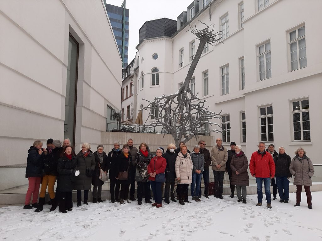 Der Friedberger Geschichtsverein im Schnee auf dem Vorplatz des Jüdischen Museums vor der Skulptur von Ariel Schlesinger.